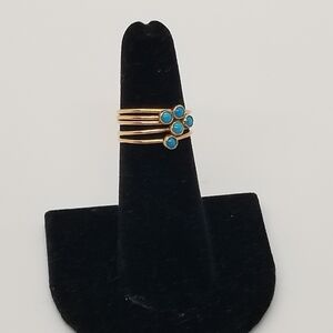 set of 5 gold tone stacking rings with small blue cabochon size 5.25